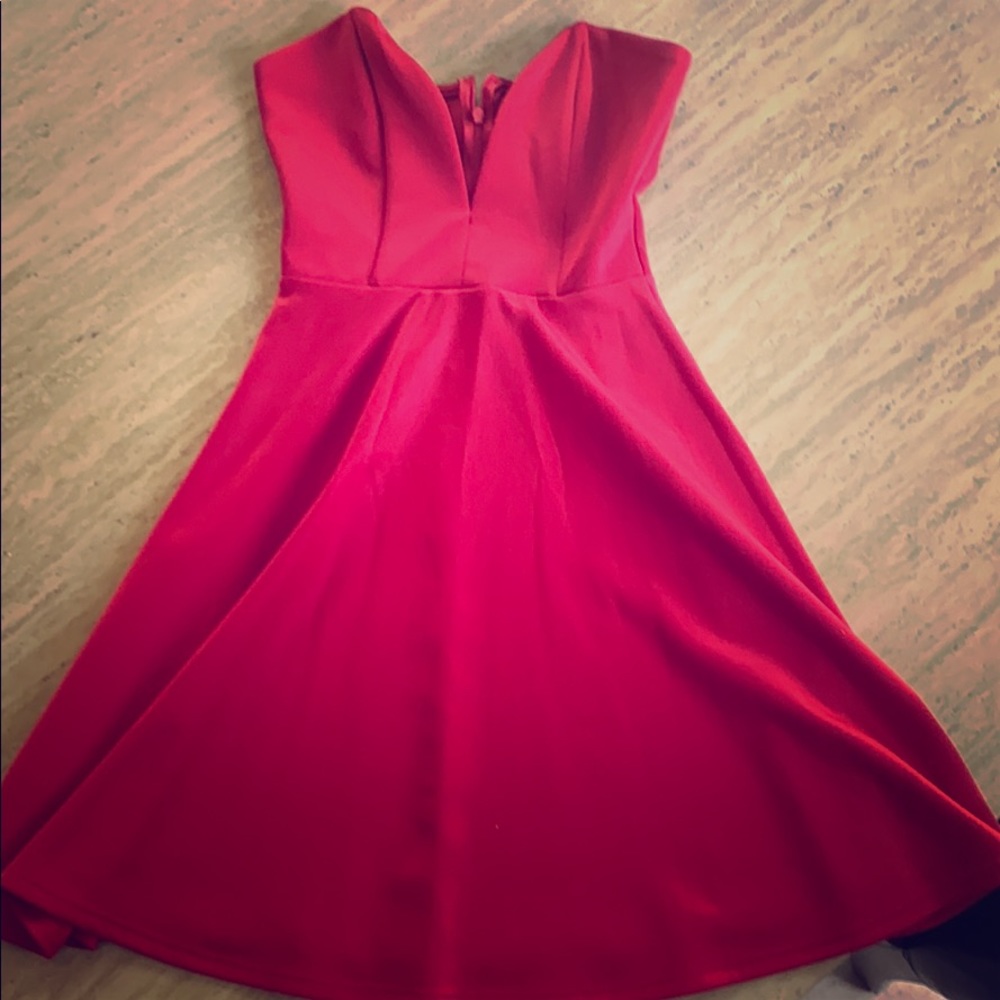 Lady in red party dress. V cut. Fit and flare